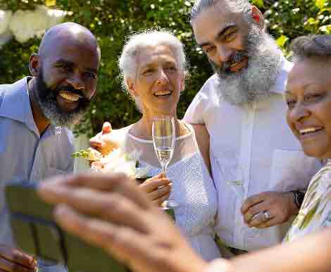 Group of Seniors Enjoying Champagne in Assisted Living Facility Group of Seniors Enjoying Champagne in Assisted Living Facility